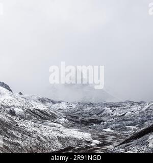 Monochrome mountain landscape. Squared image with contours of mountain in the fog. Himalayas, Nepal. Stock Photo