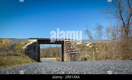 A View of a Old Narrow Gauge Rail Road Bridge, Sitting Waiting for a Train to Go Over it, on a Sunny Day Stock Photo