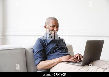 Businessman working on laptop at home Stock Photo