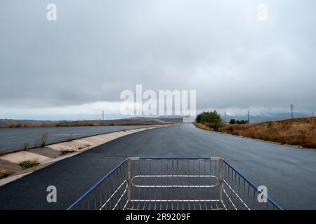 A low-angle shot of an empty shopping cart located in an open area in the countryside Stock Photo