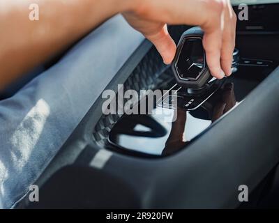 Man using gearshift in modern car Stock Photo