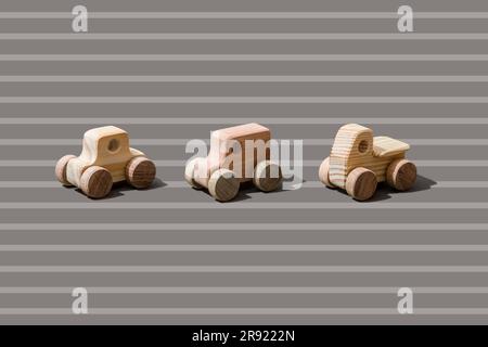 Wooden cars on stripped background Stock Photo