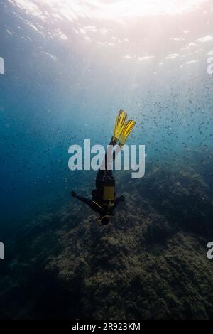 Woman doing scuba diving undersea Stock Photo