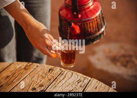 Hands of woman pouring tea in cup Stock Photo
