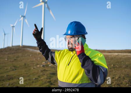 Engineer gesturing and talking on smart phone Stock Photo