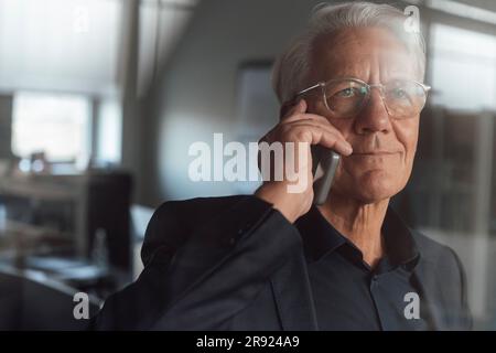 Senior businessman talking on smart phone Stock Photo