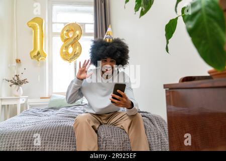 Happy man doing video call celebrating birthday at home Stock Photo