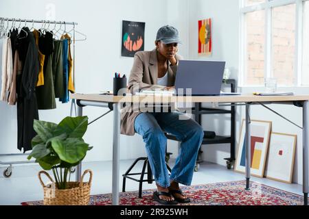 Young businesswoman using laptop on desk at office Stock Photo
