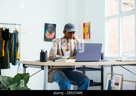 Young freelancer working on laptop at office Stock Photo