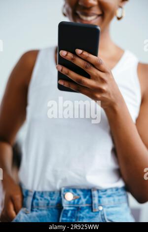 Freelancer surfing net through smart phone at office Stock Photo