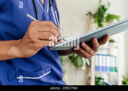 Doctor using tablet pc at healthcare clinic Stock Photo