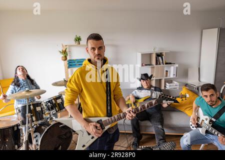 Musicians practicing with musical instruments together at home Stock Photo