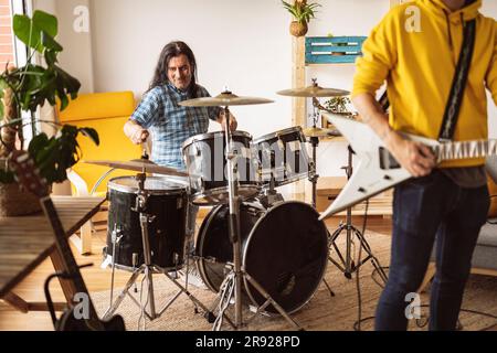 Musicians playing guitar and drum at home Stock Photo