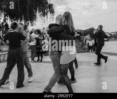 05-14-2023 Paris, France 'Tango in Paris' : Tango on riverbank of Seine in fantastic May.  pairs dancing. Stylized in monochrome. Stock Photo