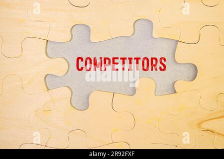 Business concept. The alarm clocks have a sticker with the inscription - COMPETITOR ANALYSIS. There are office items in the background in a blurry bac Stock Photo