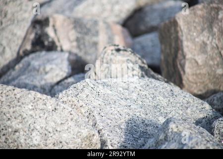 close up of granite stone rock chunks background, rock textures, river embankment, landscaping Stock Photo