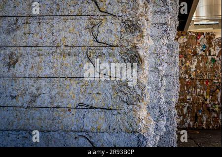 Stacked packages of shredded waste paper for recycling in Switzerland. Environment conservation. Stock Photo