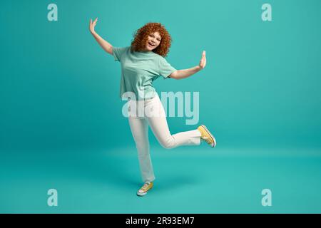 Full-length portrait of amazing positive young red-haired teenage woman Stock Photo