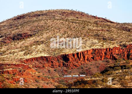 Road train truck dwarfed by the Munjina Gorge landscape, Pilbara,  Western Australia Stock Photo