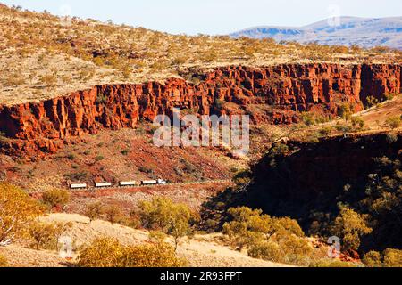 Road train truck dwarfed by the Munjina Gorge landscape, Pilbara,  Western Australia Stock Photo