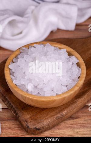 Lemon salt or Citric acid on wood background. Citric acid or lemon salt in wooden bowl Stock Photo