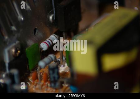 Old Macro-photo of carbon resistors on old circuit board / PCB Stock Photo