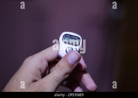 2 Digit Number Hand white colored Tally Counter Clicker in male hand Stock Photo