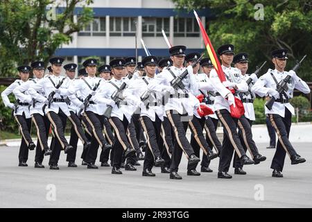 The police officers march with the flags of China and Hong Kong during the parade. A police passing out parade is held at the Hong Kong Police College. More than one hundred police officers have graduated from the Police College this month. The parade symbolize they have finished their studying at the police college and become a formal police officer from now on. The Deputy Commissioner of Police (Operations), Mr Yuen Yuk-kin, was the reviewing officer at the passing-out parade of probationary inspectors and recruit police constables. (Photo by Michael Ho Wai Lee/SOPA Images/Sipa USA) Stock Photo