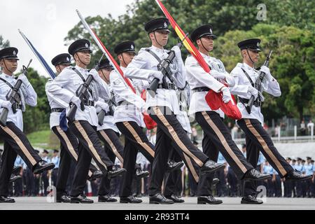 The police officers march with the flags of China and Hong Kong during the parade. A police passing out parade is held at the Hong Kong Police College. More than one hundred police officers have graduated from the Police College this month. The parade symbolize they have finished their studying at the police college and become a formal police officer from now on. The Deputy Commissioner of Police (Operations), Mr Yuen Yuk-kin,  was the reviewing officer at the passing-out parade of probationary inspectors and recruit police constables. (Photo by Michael Ho Wai Lee / SOPA Images/Sipa USA) Stock Photo