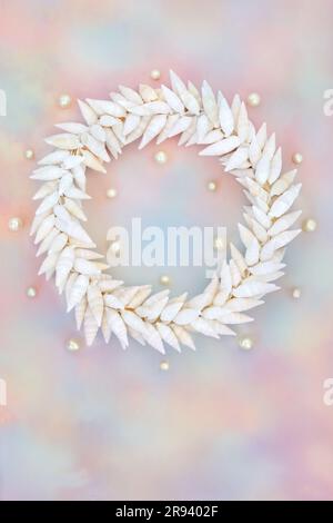 Cerithium sea snail shell and pearl wreath on rainbow sky cloud background. Summer nature abstract design for greeting card. Stock Photo