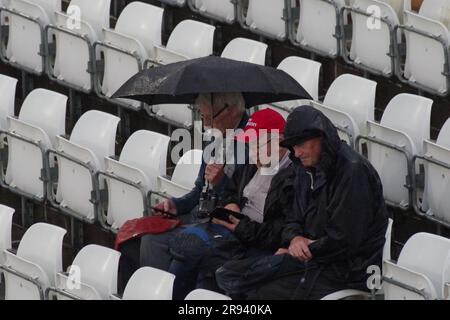 Chester le Street, 23 June 2023. Spectators sheltering from the rain at the Vitality Blast match between Durham Cricket and Yorkshire Vikings at Seat Unique Riverside, Chester le Street. Credit: Colin Edwards Stock Photo