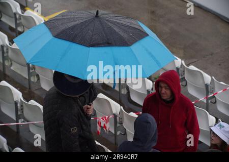 Chester le Street, 23 June 2023. Spectators sheltering from the rain at the Vitality Blast match between Durham Cricket and Yorkshire Vikings at Seat Unique Riverside, Chester le Street. Credit: Colin Edwards Stock Photo