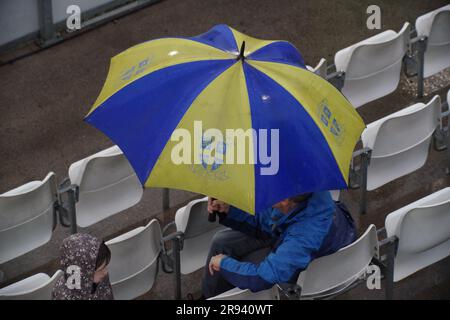 Chester le Street, 23 June 2023. Spectators sheltering from the rain at the Vitality Blast match between Durham Cricket and Yorkshire Vikings at Seat Unique Riverside, Chester le Street. Credit: Colin Edwards Stock Photo