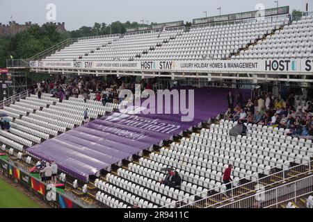 Chester le Street, 23 June 2023. Spectators sheltering from the rain at the Vitality Blast match between Durham Cricket and Yorkshire Vikings at Seat Unique Riverside, Chester le Street. Credit: Colin Edwards Stock Photo