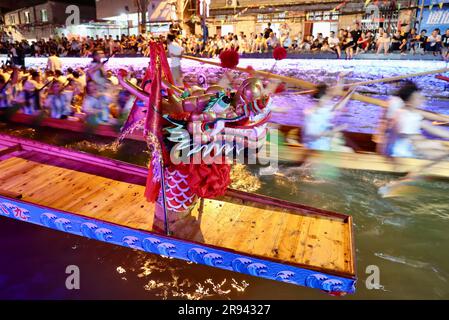 (230624) -- FUZHOU, June 24, 2023 (Xinhua) -- People race dragon boats on a river acrossing Sanxi Village in Fuzhou of southeast China's Fujian Province, on June 18, 2023. The Dragon Boat Festival, also known as Duanwu Festival, traditionally falls on the fifth day of the fifth month in the Chinese lunar calendar. The dragon boat competition, a traditional part of the festival, has gained popularity on both sides of the Taiwan Strait, bringing excitement to a wide range of people. Located on the southeastern coast of China, Fujian Province is ideal for water sports with its widely scattered r Stock Photo