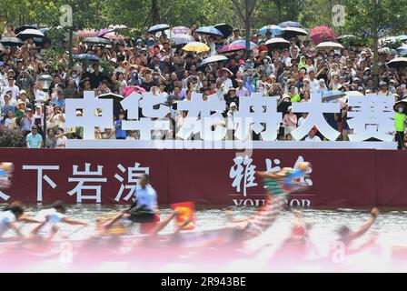 (230624) -- FUZHOU, June 24, 2023 (Xinhua) -- People watch a dragon boat race in Fuzhou of southeast China's Fujian Province, on June 22, 2023. The Dragon Boat Festival, also known as Duanwu Festival, traditionally falls on the fifth day of the fifth month in the Chinese lunar calendar. The dragon boat competition, a traditional part of the festival, has gained popularity on both sides of the Taiwan Strait, bringing excitement to a wide range of people.  Located on the southeastern coast of China, Fujian Province is ideal for water sports with its widely scattered rivers, lakes and the sea. On Stock Photo