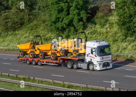 LOGISTICA Brit European Group. 2023 White Renault Truck T with step-frame trailer carrying new JCB 6T-2, 6 tonnes Site Dumper trucks; travelling on the M6 motorway in Greater Manchester, UK Stock Photo