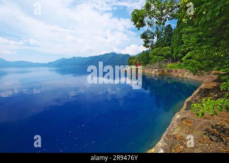 Lake Tazawa and Torii Gate of Ozaishi Shrine Stock Photo