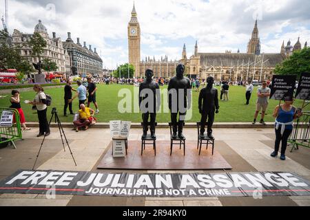 A sculpture called Anything To Say, which features life-sized bronze figures of whistleblowers (left-right) Edward Snowden, Julian Assange and Chelsea Manning, each standing on their own individual chair, is unveiled at Parliament Square, London, during a protest to step up demands for the release from prison of WikiLeaks founder Julian Assange. Campaigners and supporters will march through central London as Assange faces extradition to the United States, where he fears being imprisoned for the rest of his life. Picture date: Saturday June 24, 2023. Stock Photo