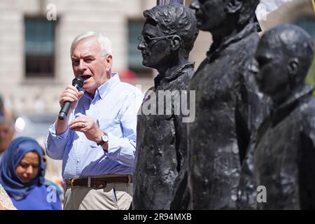 John McDonnell speaks alongside a sculpture called Anything To Say, which features life-sized bronze figures of whistleblowers (left-right) Edward Snowden, Julian Assange and Chelsea Manning, each standing on their own individual chair, at Parliament Square, London, during a protest to step up demands for the release from prison of WikiLeaks founder Julian Assange. Campaigners and supporters will march through central London as Assange faces extradition to the United States, where he fears being imprisoned for the rest of his life. Picture date: Saturday June 24, 2023. Stock Photo