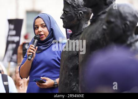 Apsana Begum speaks alongside a sculpture called Anything To Say, which features life-sized bronze figures of whistleblowers (left-right) Edward Snowden, Julian Assange and Chelsea Manning, each standing on their own individual chair, at Parliament Square, London, during a protest to step up demands for the release from prison of WikiLeaks founder Julian Assange. Campaigners and supporters will march through central London as Assange faces extradition to the United States, where he fears being imprisoned for the rest of his life. Picture date: Saturday June 24, 2023. Stock Photo