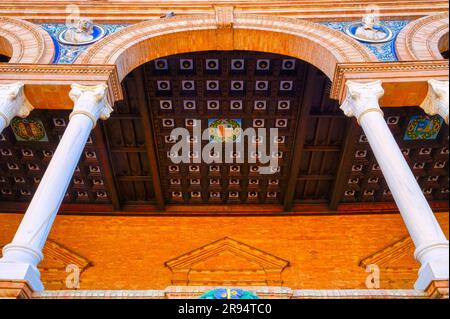 Seville, Spain - January 20, 2023: Plaza de España. The porch ceiling by the Salamanca bay. The coat of arms of the region is in the center of the woo Stock Photo