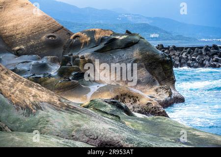 A telephoto shot of an eerie rock formation in Yehliu Geopark. Stock Photo