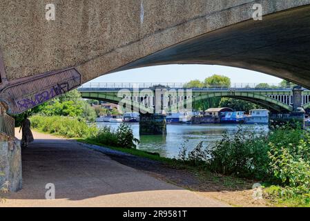 Richmond railway bridge passing over the River Thames with Twickenham road bridge in the foreground, Richmond Greater London England UK Stock Photo