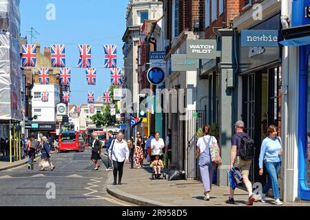 A busy George Street decorated with union flags in Richmond on Thames on a sunny summers day Greater London England UK Stock Photo