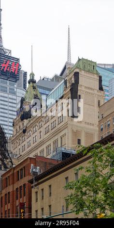 NYC landmark New York Times Building was built in four stages and three styles, with a copper-clad pyramidal roof and cupola capping the tower. Stock Photo