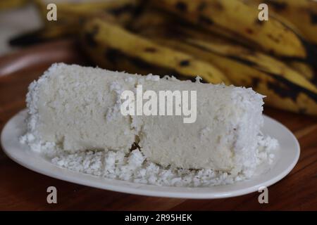 Puttu, Steamed rice cake made of rice flour and freshly grated coconut. Traditional kerala breakfast. Steamed in a cylindrical steel mould. Served wit Stock Photo