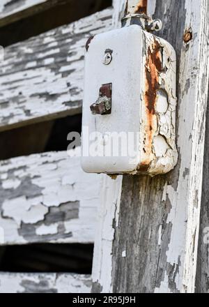 vintage old electrical switch on the outside barn door Stock Photo