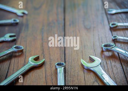Metal bunch wrench  tools lying on dark wooden background and top view Stock Photo