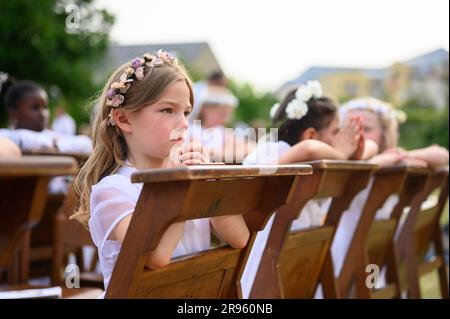 Children praying after receiving the First Holy Communion. Stock Photo